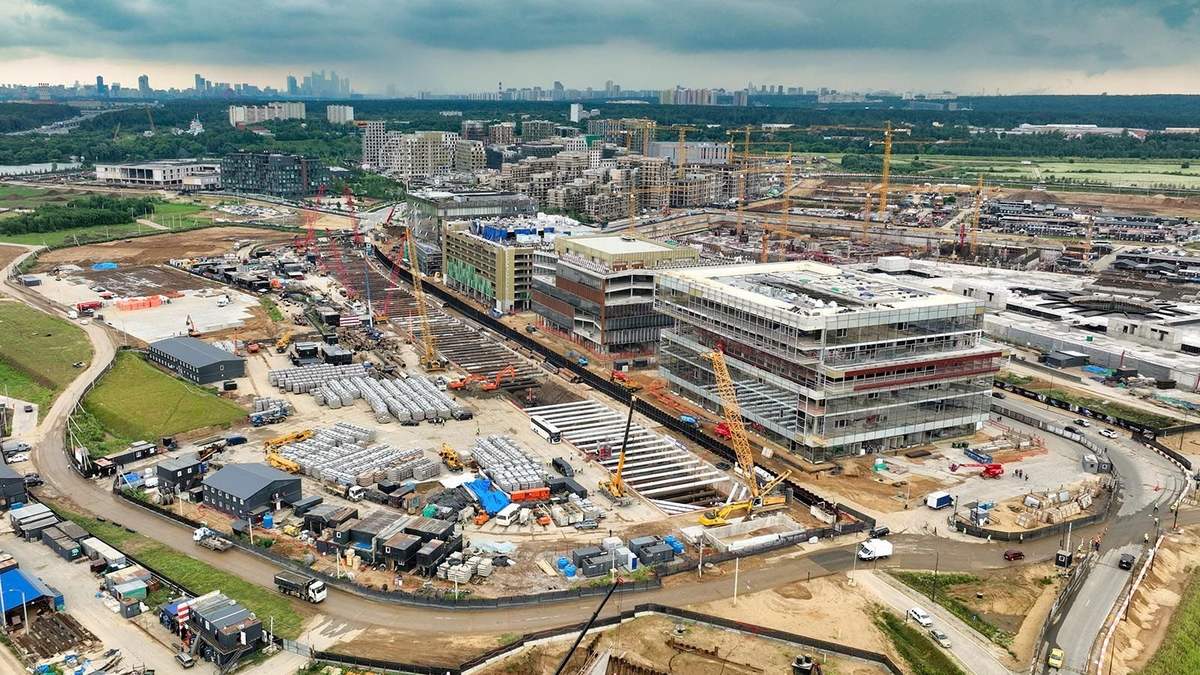 Генподрядчики Москвы: строительная площадка ЖК «СберСити» с башенными кранами, корпусами и складом конструкций с высоты